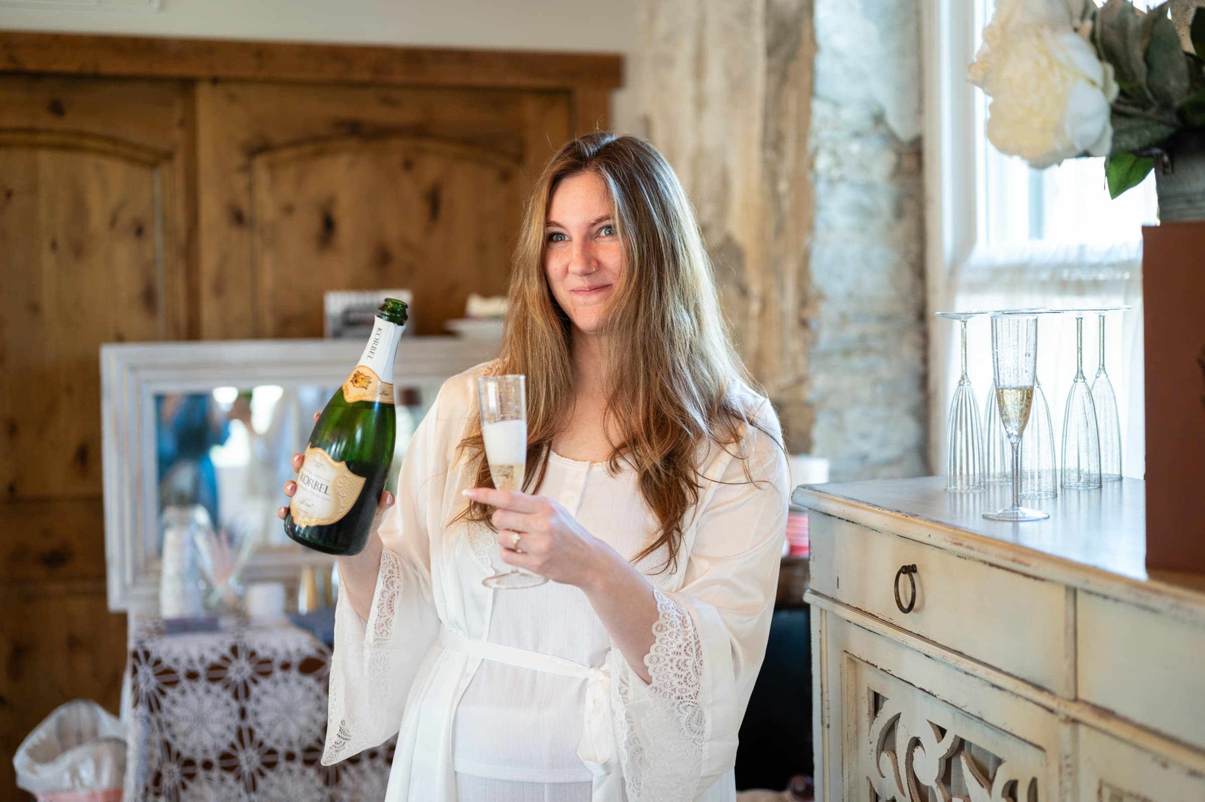 Bride with Champagne at Sinclair of Skaneateles in Skaneateles, NY | Finger Lakes Wedding Photography