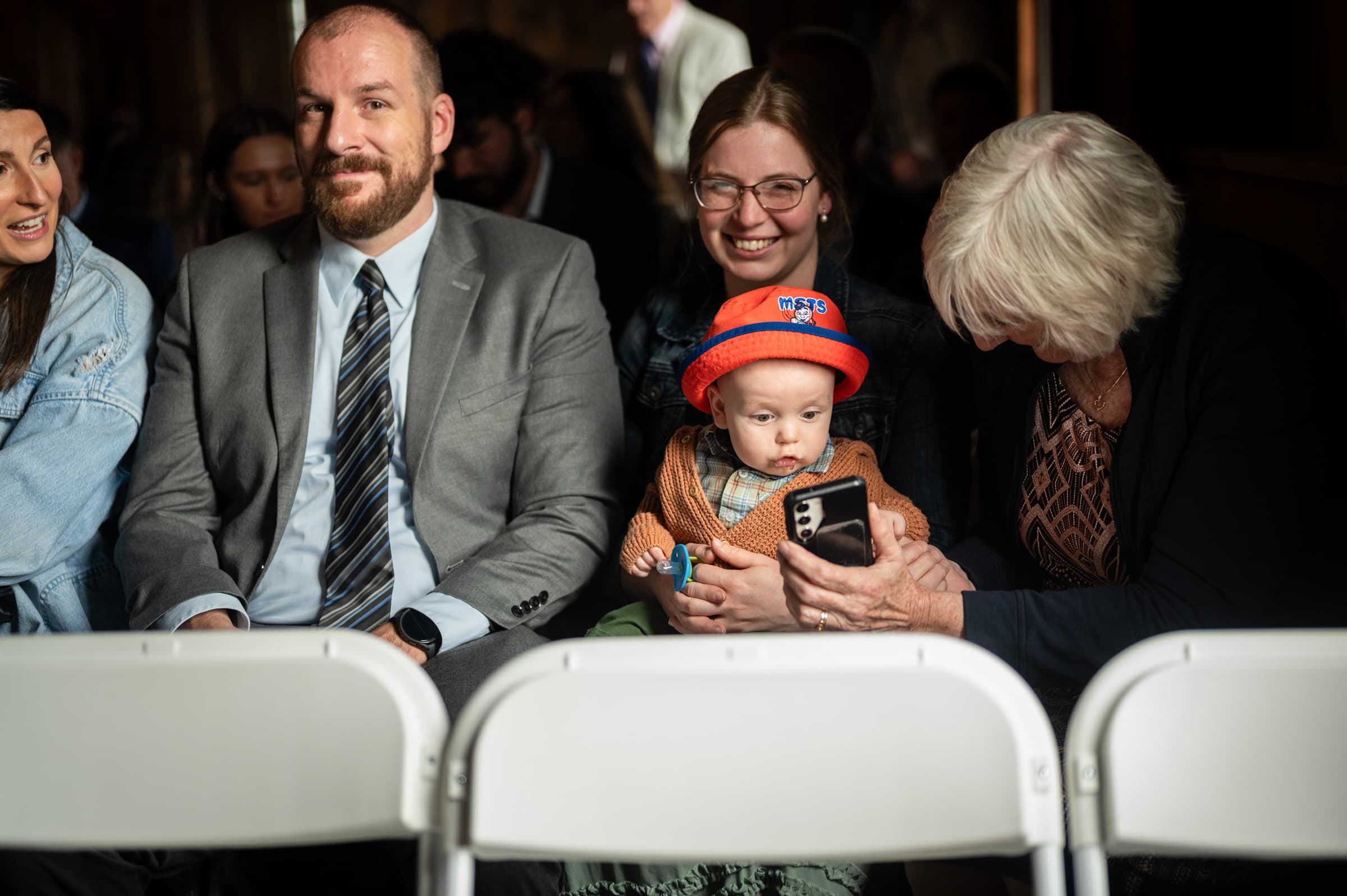 Baby amazed by phone at Cobblestone Wedding Barn in Scottsville, NY | Rochester Wedding Photography