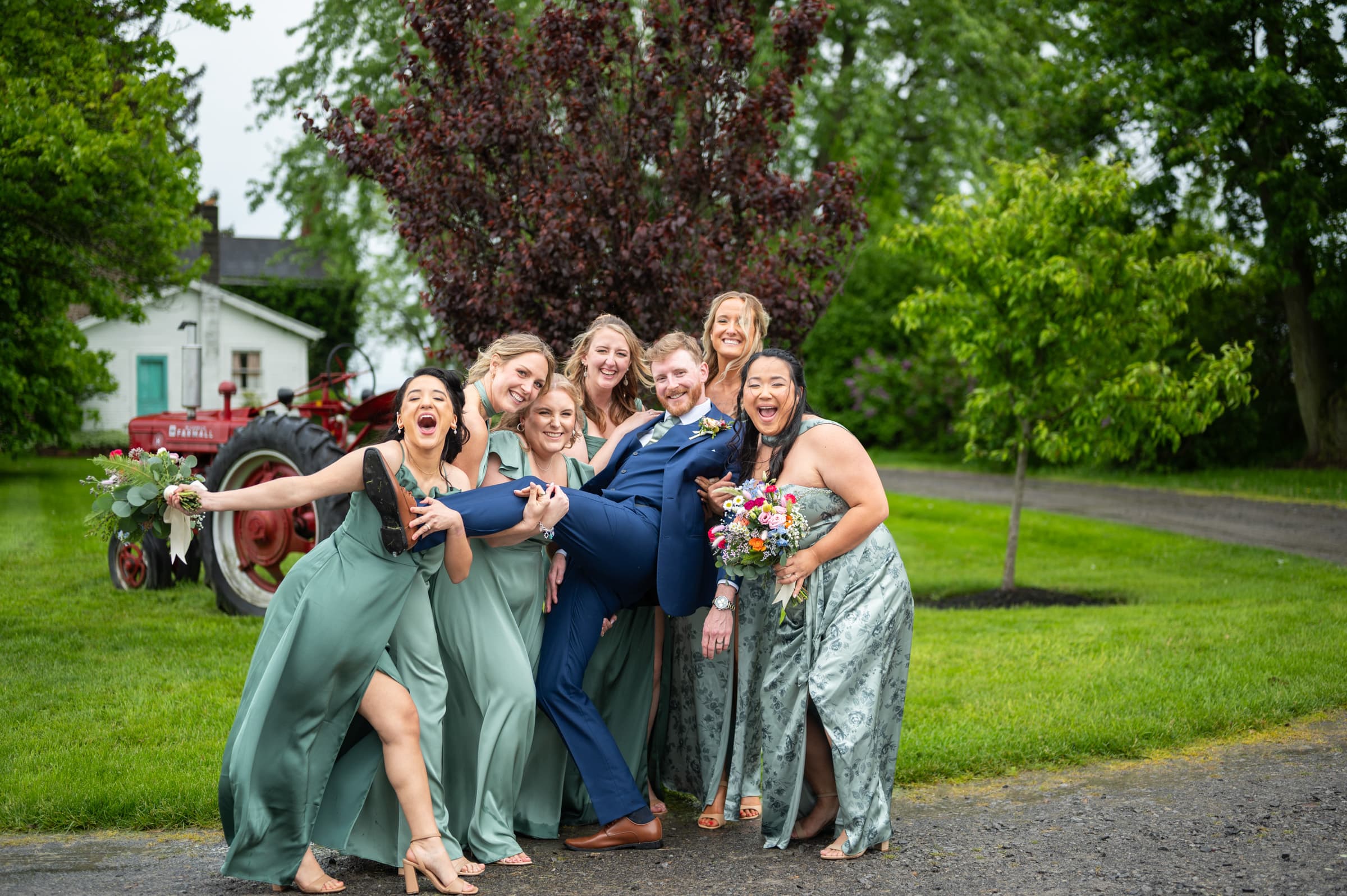 Groom being silly with bridesmaids at Cobblestone Wedding Barn in Scottsville, NY | Rochester Wedding Photography