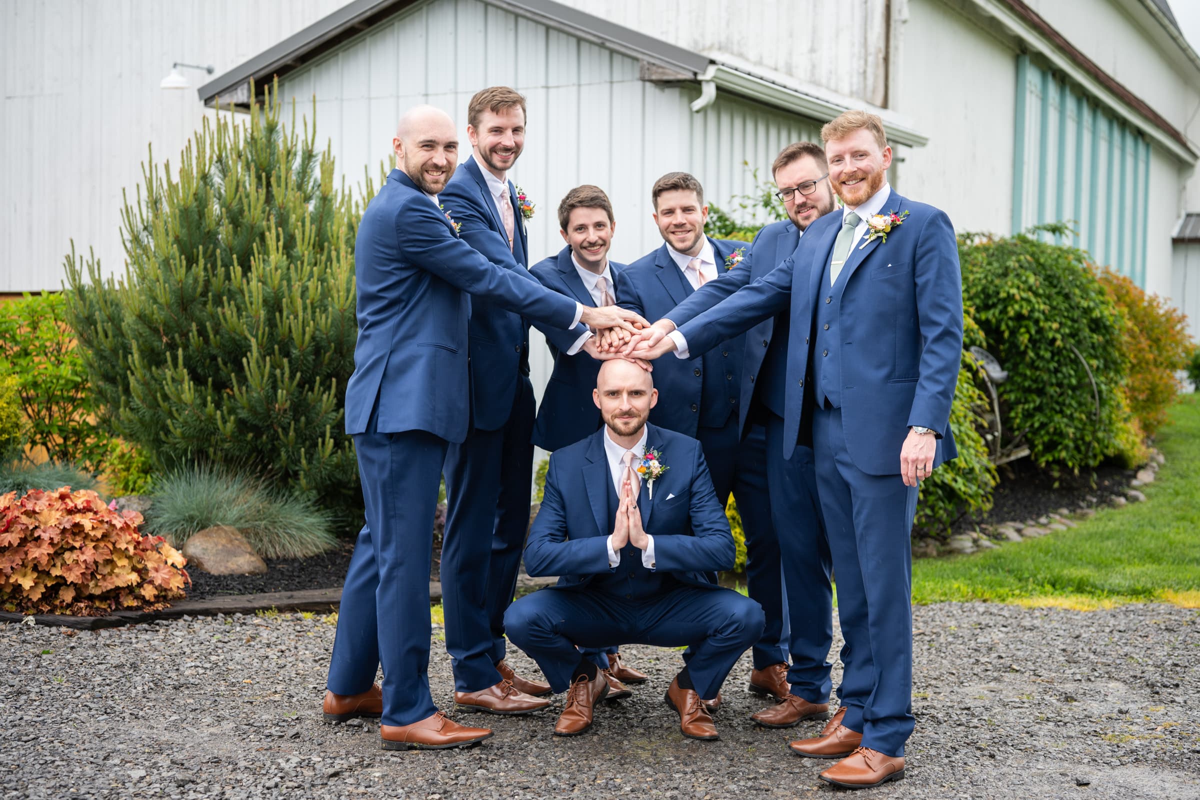 Groomsmen worshipping bald guy at Cobblestone Wedding Barn in Scottsville, NY | Rochester Wedding Photography