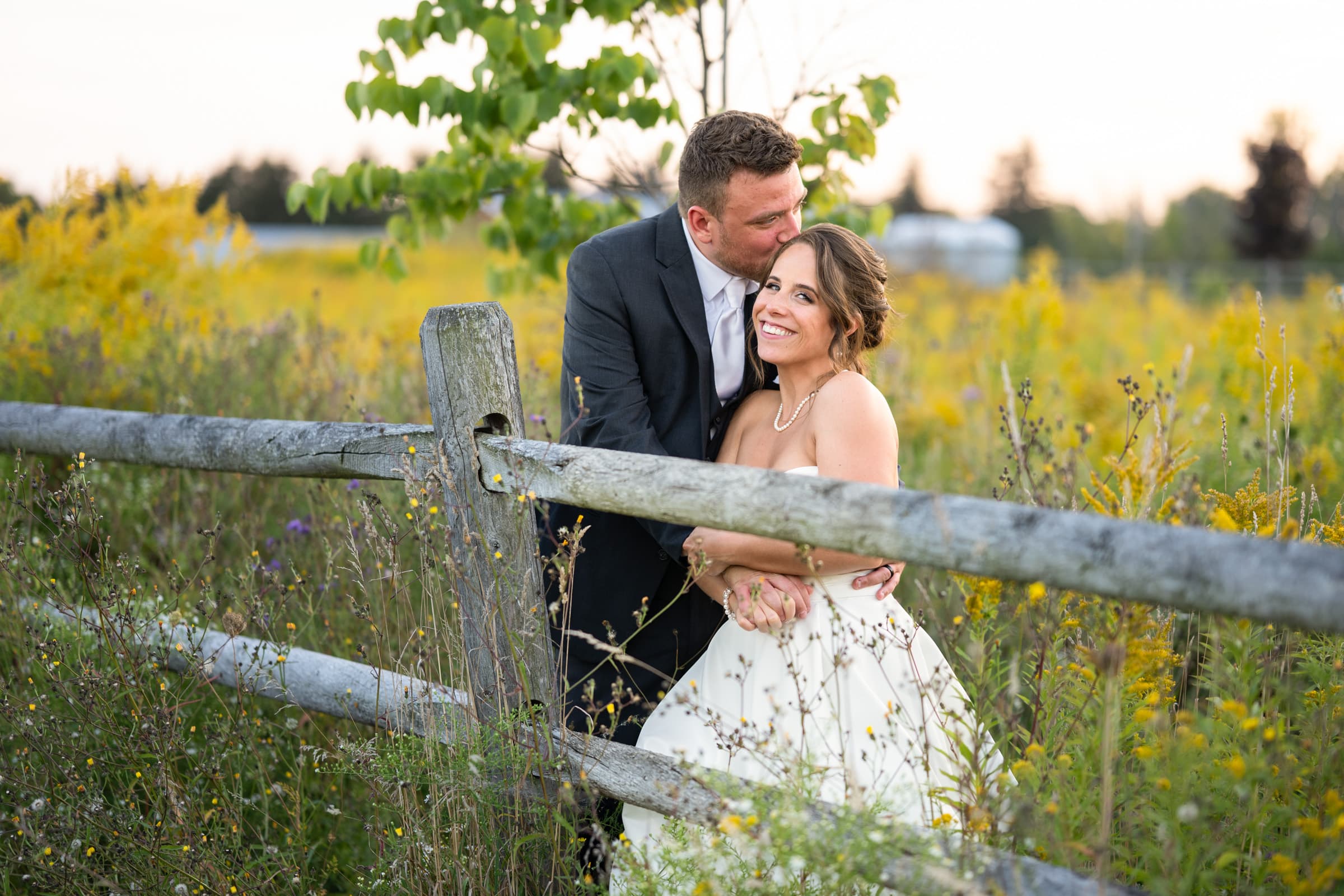 Couple in field at Pamona Blue Barn in Hilton, NY | Rochester Wedding Photography