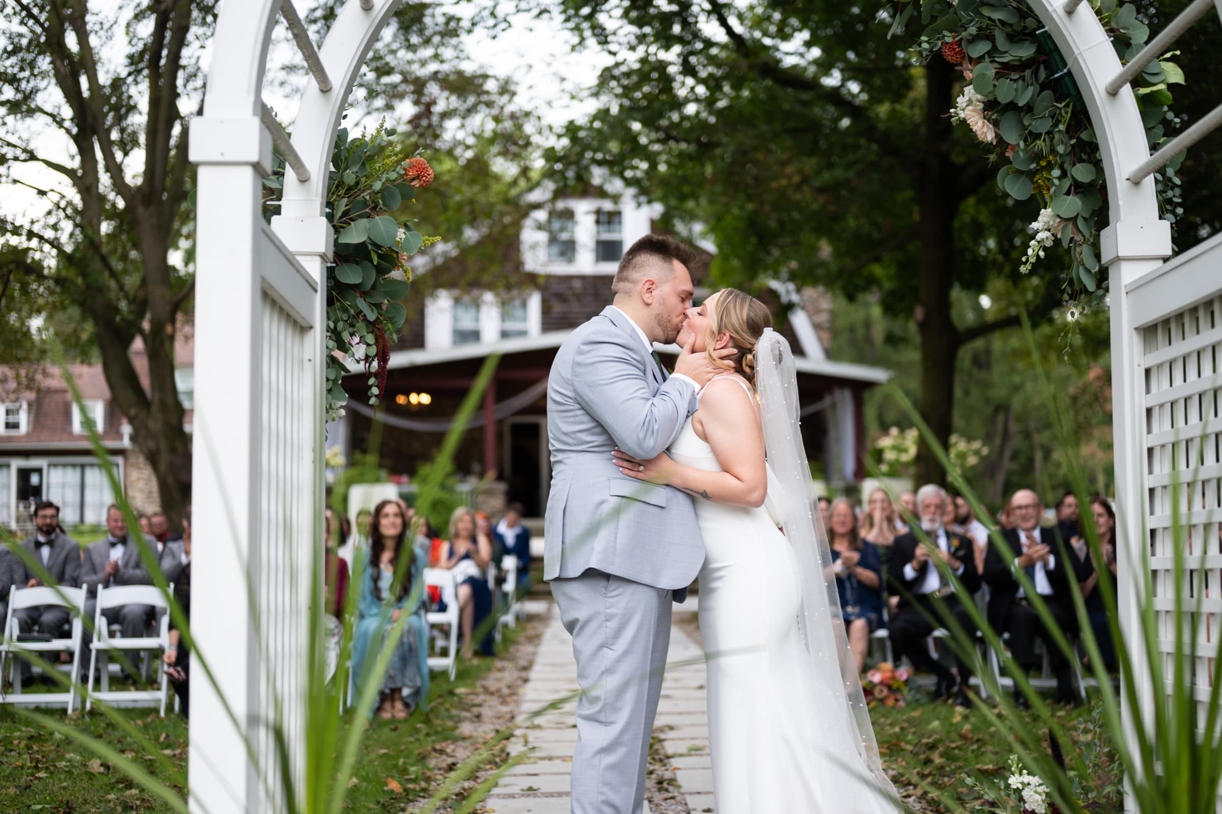 First kiss while guests watch at Hillcrest Estate in Pavilion, NY | Western New York Wedding Photography